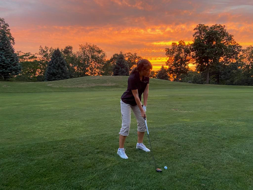 Putting on the greens at sunset